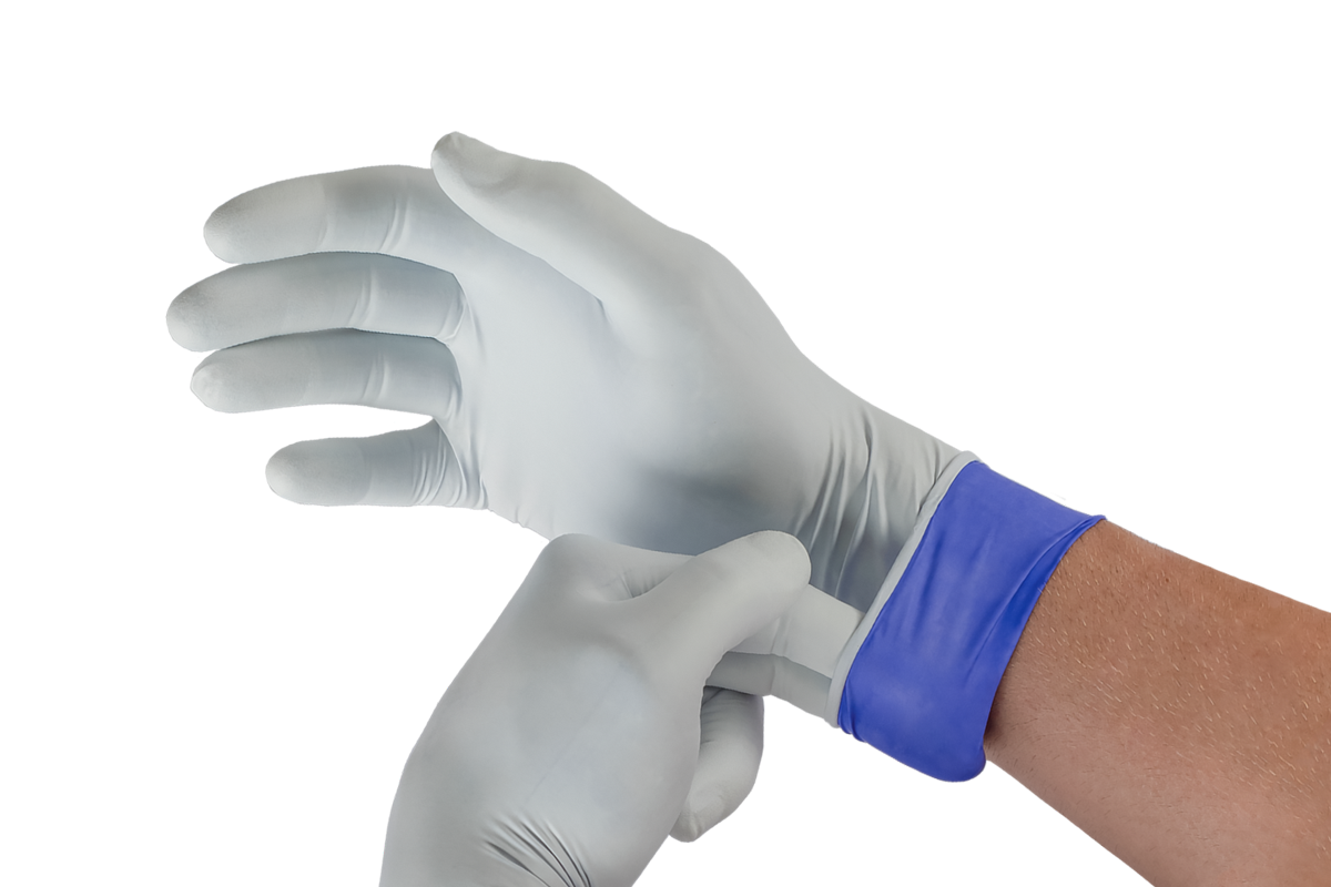 A provider pulling on a pair of examination gloves